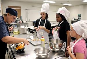 students cooking with instructor